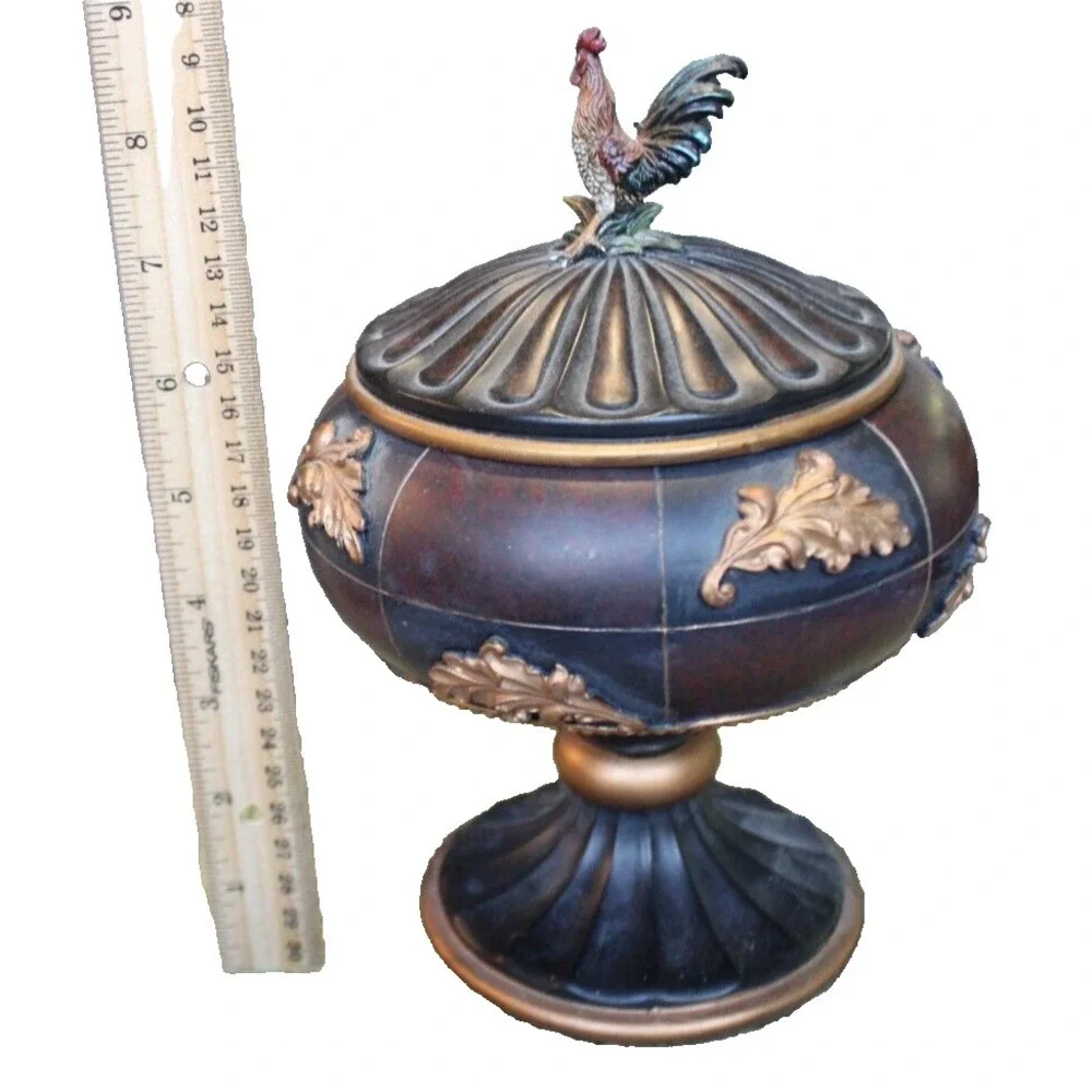 Notions container in form of large lidded pedestal cup with rooster on top